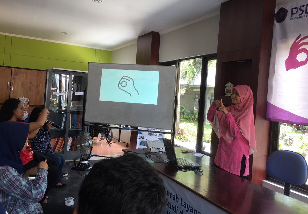 Seorang difabel Tuli memperagakan praktik berbahasa isyarat di pelatihan Bahasa Isyarat Dasar pada volunteer.